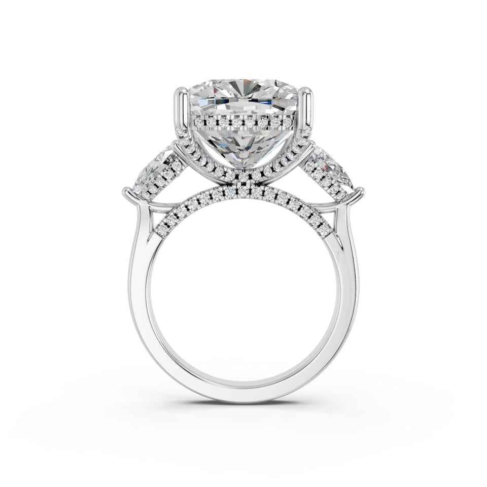 CUSHION THREE STONE RING WITH PEAR SIDE STONES AND HIDDEN HALO