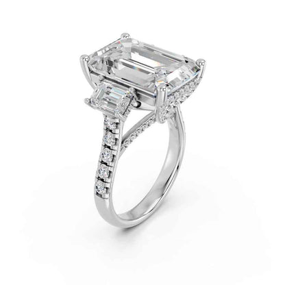 EMERALD THREE STONE RING WITH HIDDEN HALO AND PAVE BAND