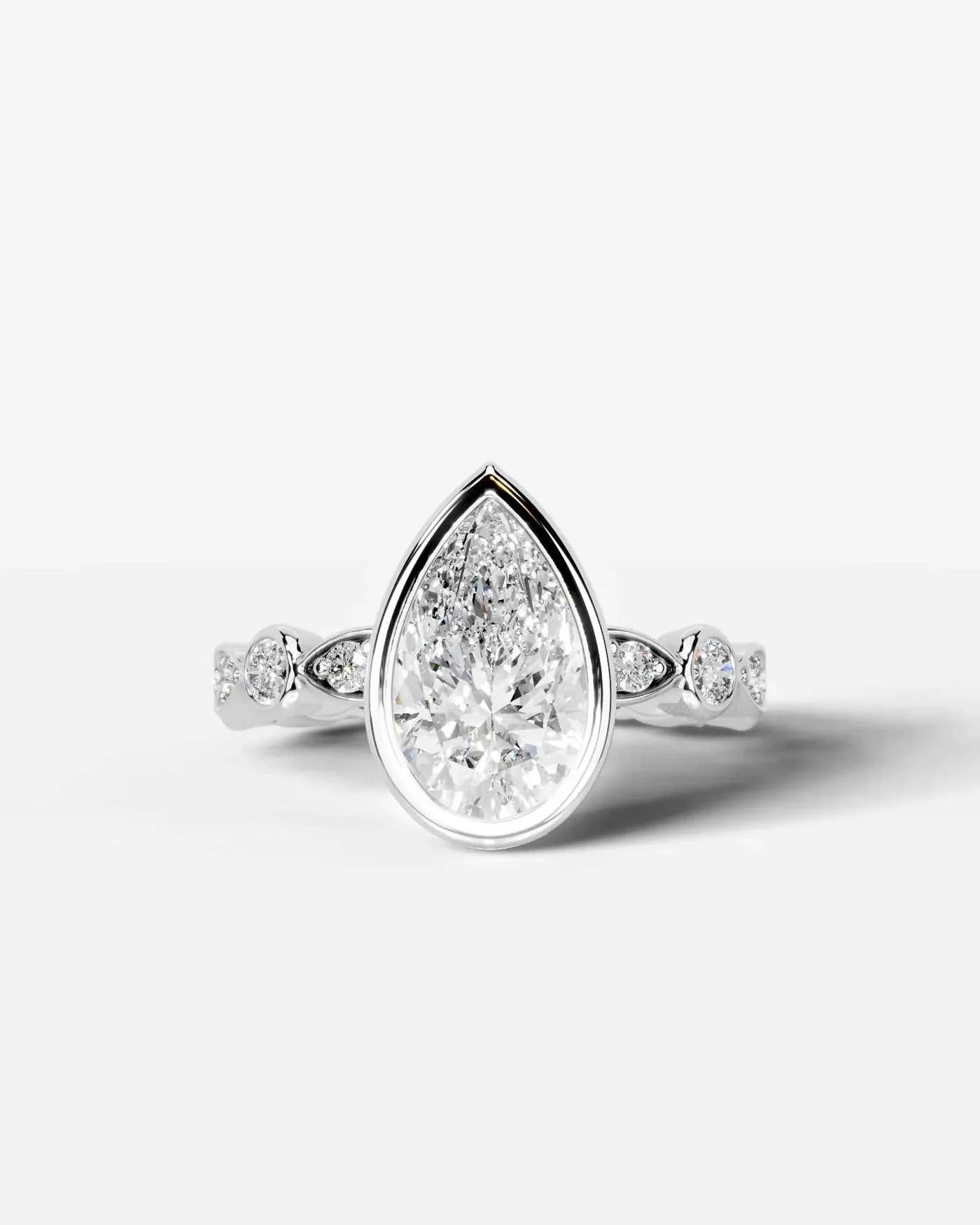 Pear Cut Lab Diamond bezel Engagement Ring with bezel set side stones| D VS1