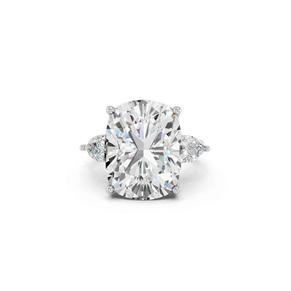 CUSHION THREE STONE RING WITH PEAR SIDE STONES AND HIDDEN HALO