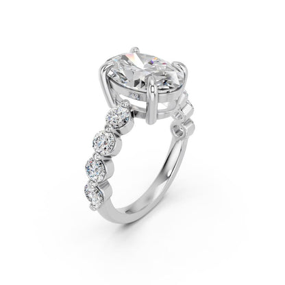 OVAL RING WITH ROUND SIDE STONES