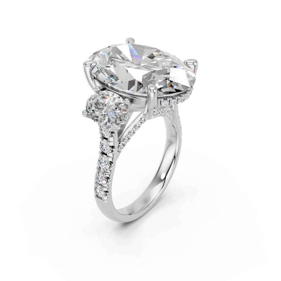 OVAL THREE STONE RING WITH HIDDEN HALO AND PAVE BAND