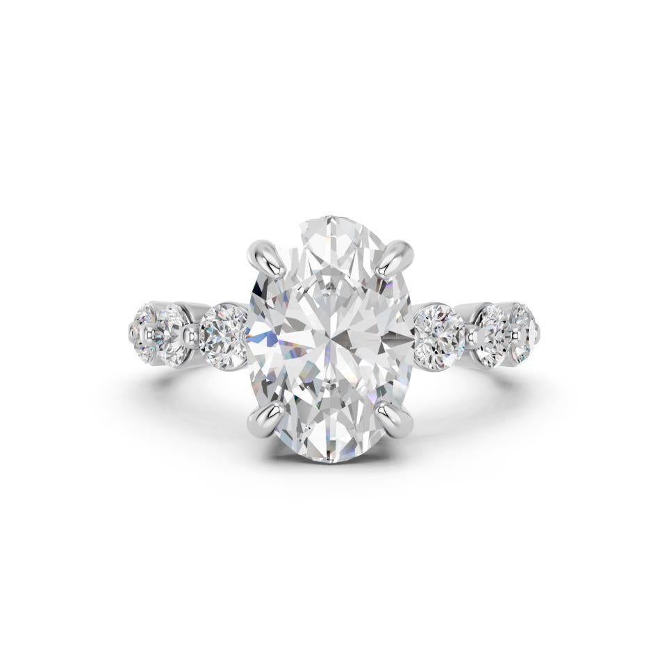 OVAL RING WITH ROUND SIDE STONES