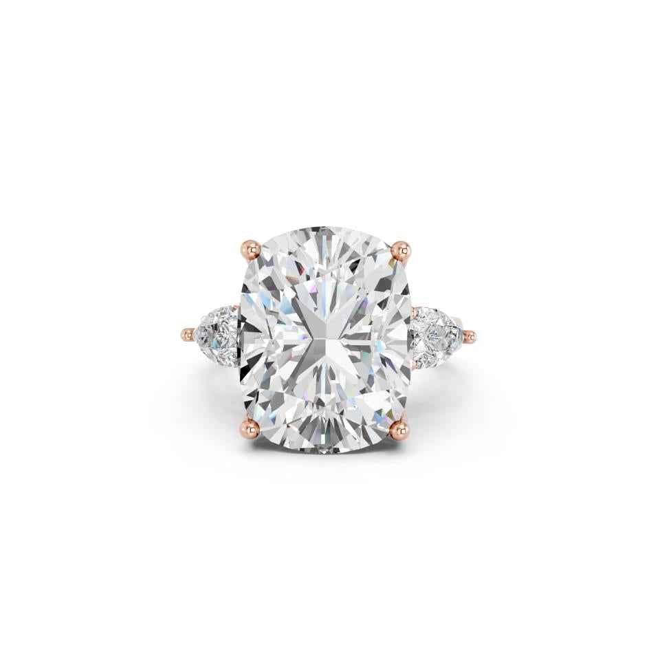 CUSHION THREE STONE RING WITH PEAR SIDE STONES AND HIDDEN HALO