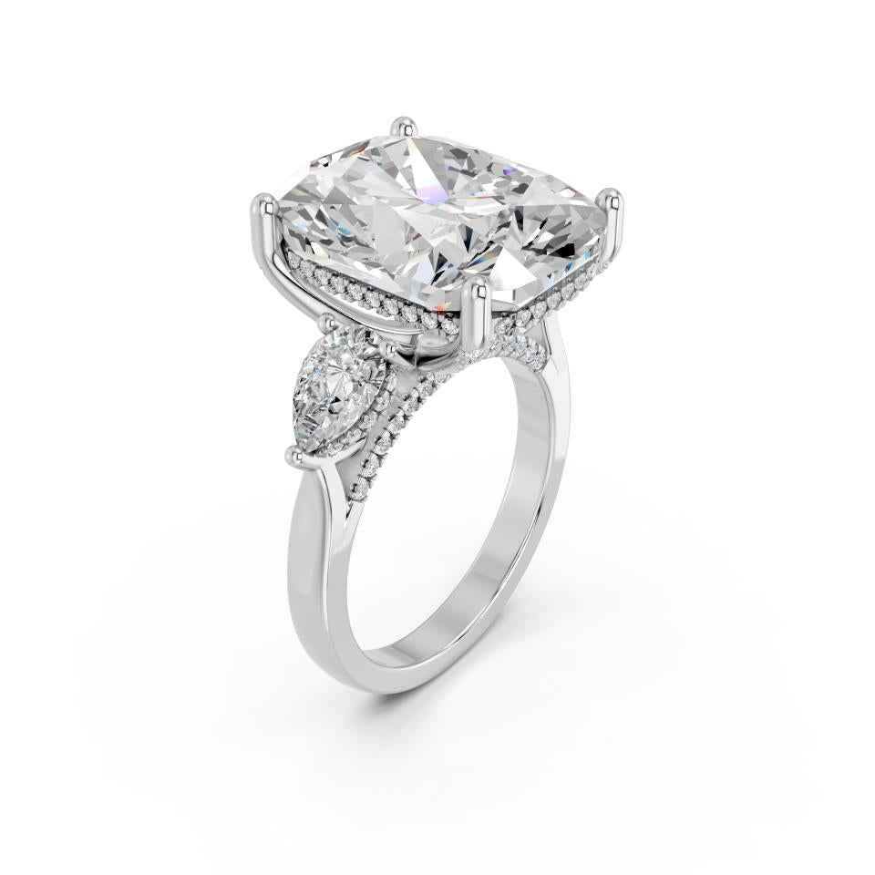 CUSHION THREE STONE RING WITH PEAR SIDE STONES AND HIDDEN HALO
