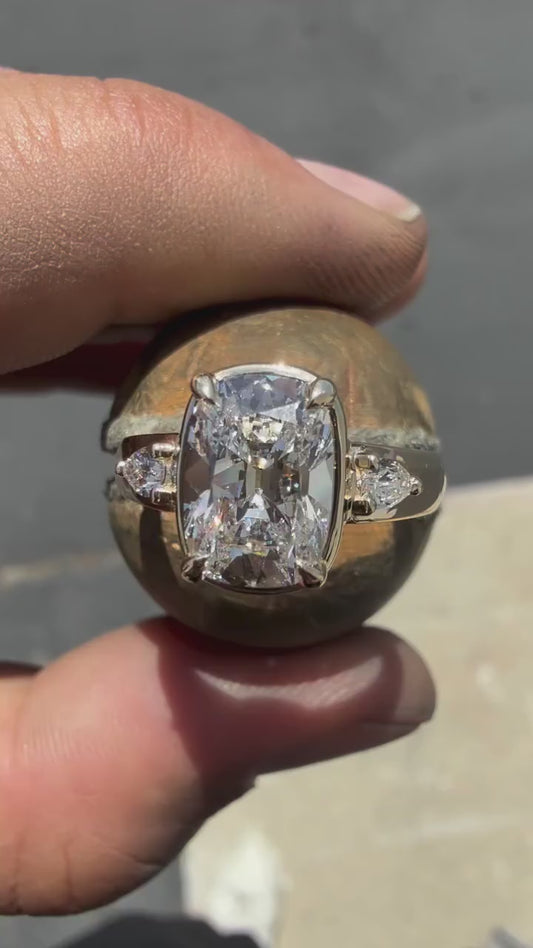 CUSHION RING WITH PEAR SIDE STONES