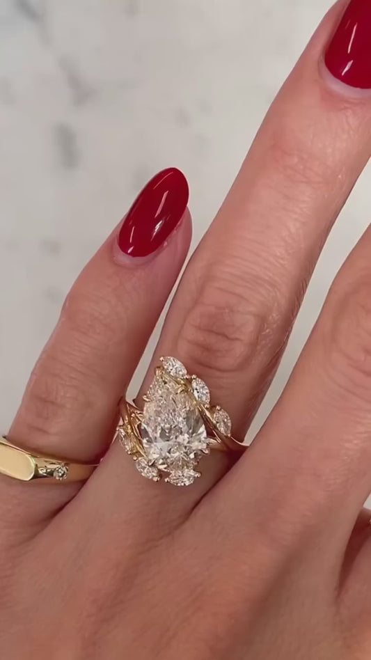 PEAR RING WITH MARQUISE SIDE STONE