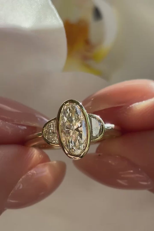 OVAL THREE STONE BEZEL RING